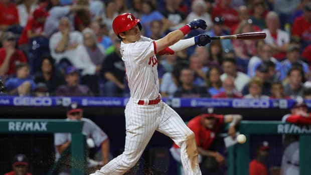 Sep 9, 2022; Philadelphia, Pennsylvania, USA; Philadelphia Phillies third baseman Dalton Guthrie (18) hits an RBI infield single during the seventh inning against the Washington Nationals at Citizens Bank Park.